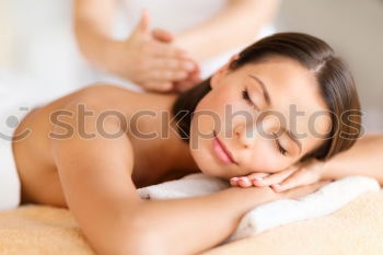 Similar – Young blond woman receiving a head massage in a spa center