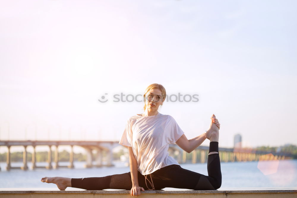 Similar – African American sportive woman sitting in lotus pose and stretching hands up