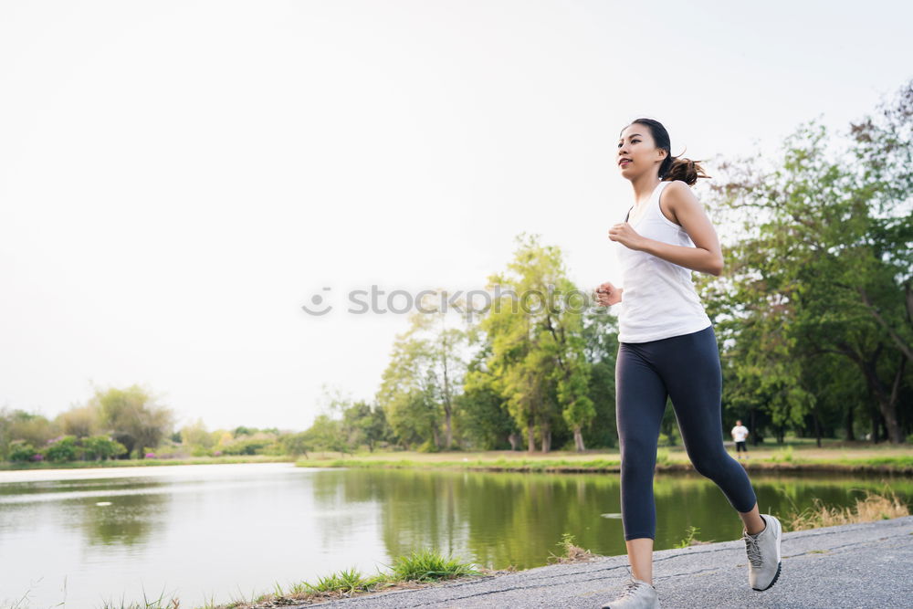 Similar – Pretty Woman Jogging at the Park with Headphones