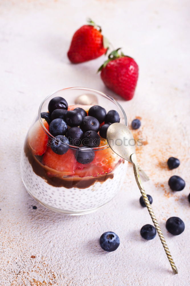 Similar – Berry-fruity water, iced with raspberries, blueberries, ice cubes and drinking straw on white background