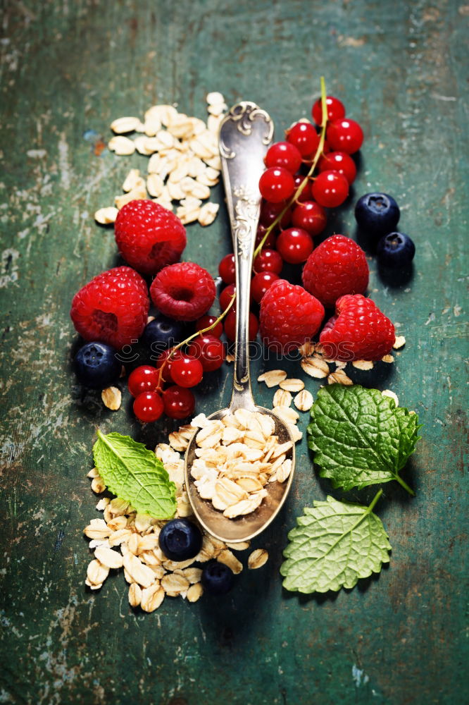 Similar – Oat flakes with berries and spoon