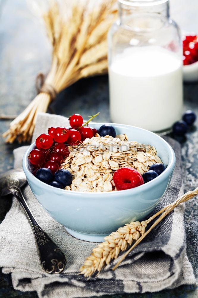 Similar – Oat flakes in blue bowl with berries