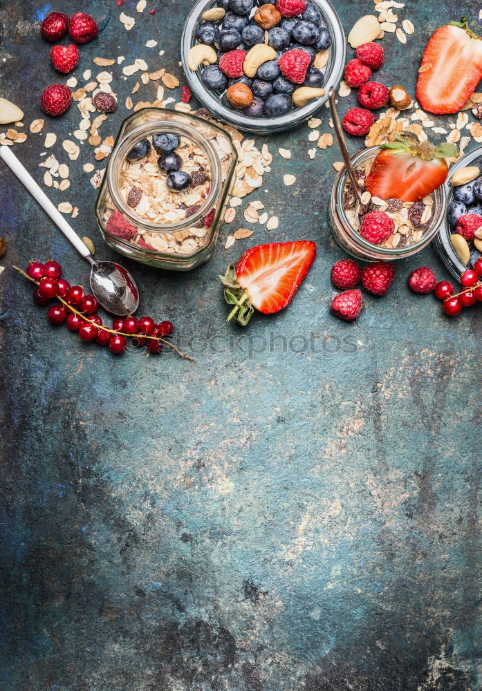 Breakfast in glasses . Muesli with berries, nuts and seeds