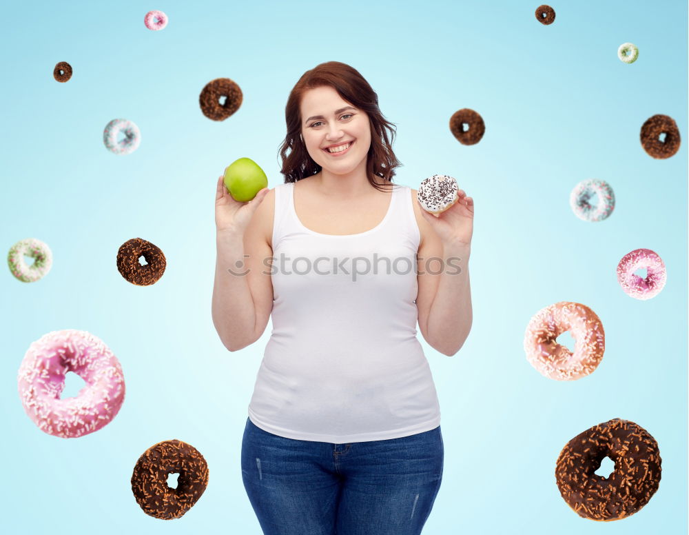 Similar – Young woman pulling funny face holding donuts in hands