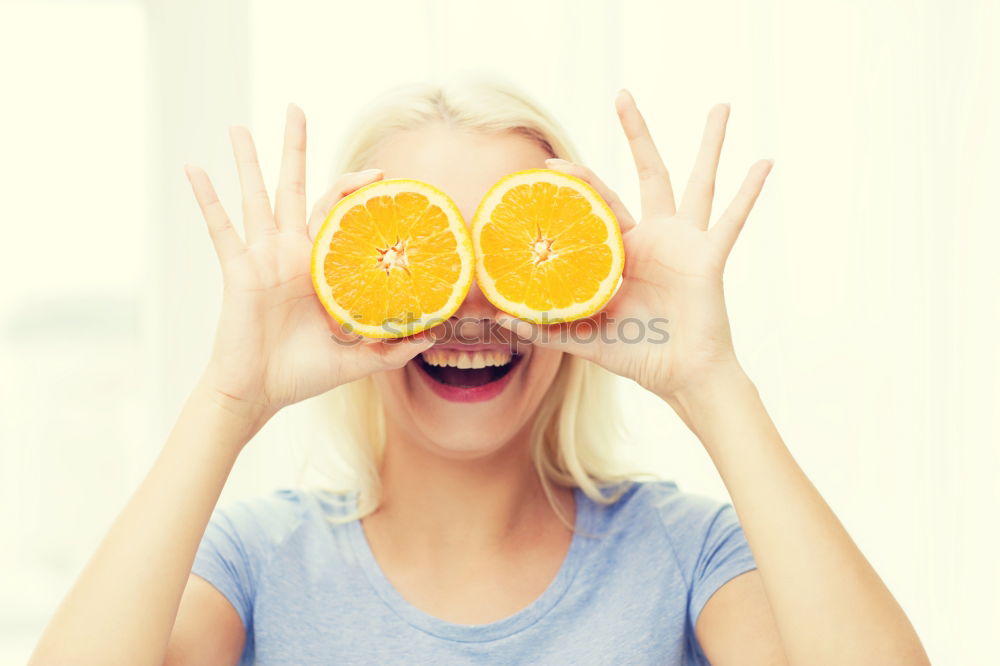 Similar – smiling little girl holding oranges over her eyes