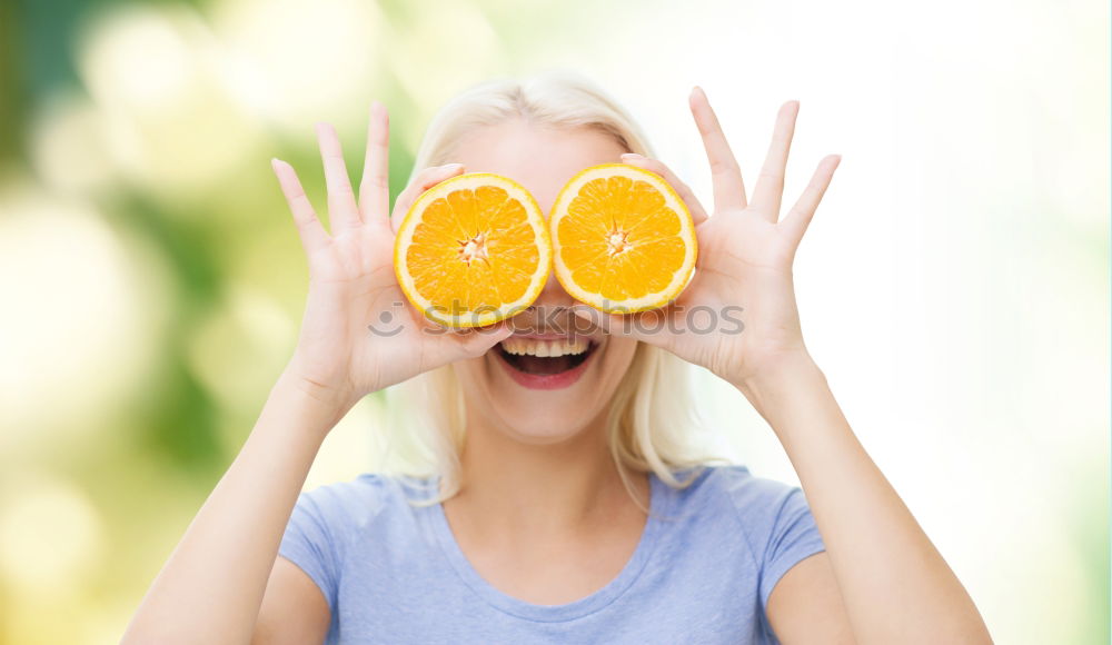 Similar – smiling little girl holding oranges over her eyes