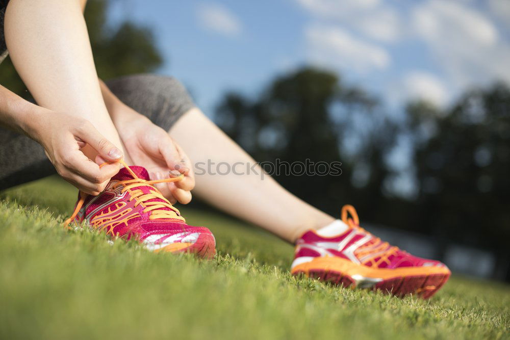 Similar – Runner get ready for run, tying sneakers shoelaces