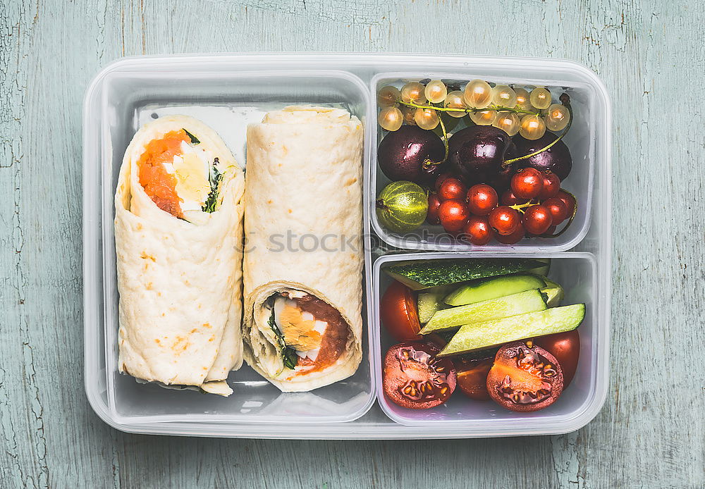 Healthy vegetarian lunch box with tortilla wraps