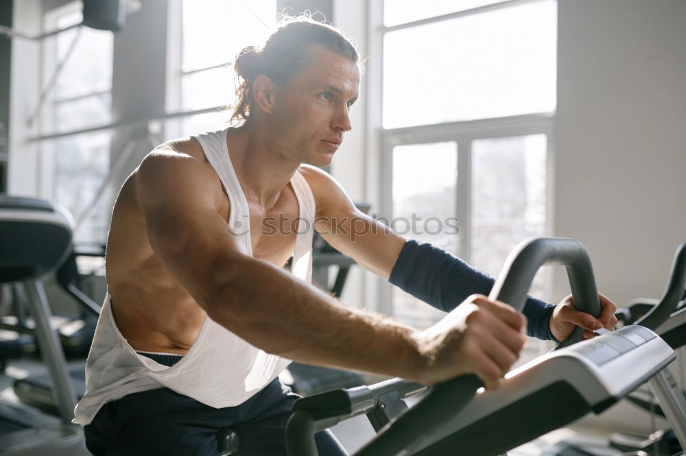 Similar – Image, Stock Photo Man setting control panel of treadmill for training