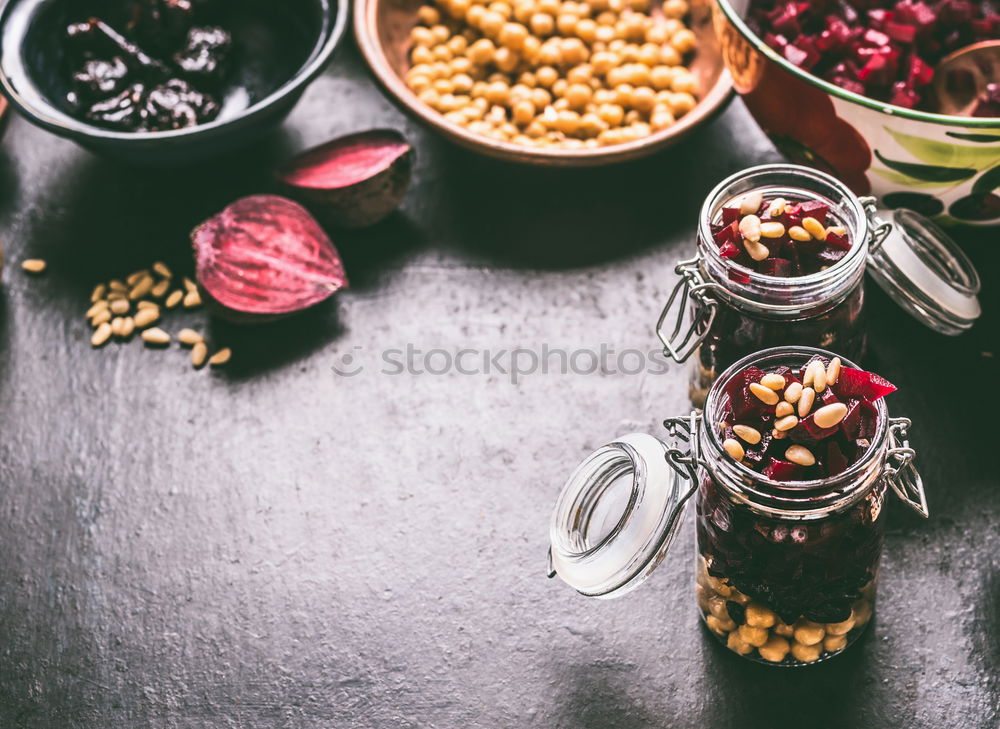 Similar – Image, Stock Photo Healthy homemade beetroot salad with chickpeas and pine nuts in glasses for lunch on dark kitchen table background with ingredients, top view. Purple vegetables eating. Clean dieting food.