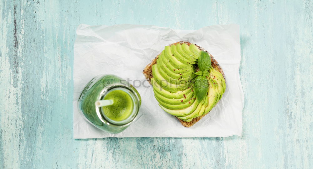 Similar – Cut avocado on white plate on pastel background