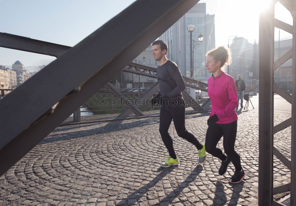 Similar – Young couple running on a seafront promenade