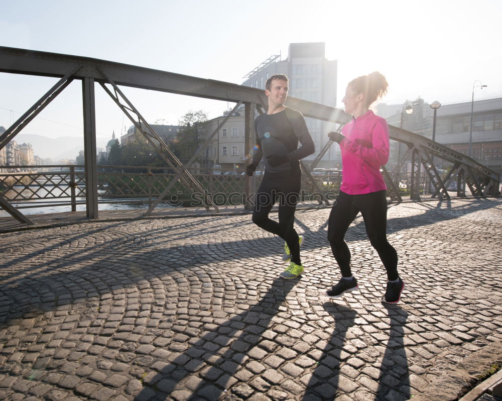 Similar – Image, Stock Photo Young couple running on a seafront promenade