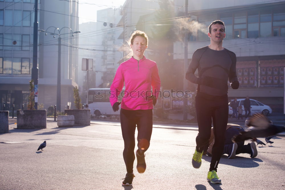 Young couple running on a seafront promenade