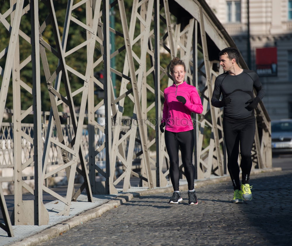 Similar – Young couple running on a seafront promenade