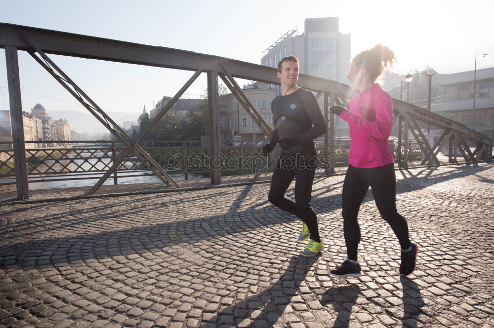 Similar – Young couple running on a seafront promenade