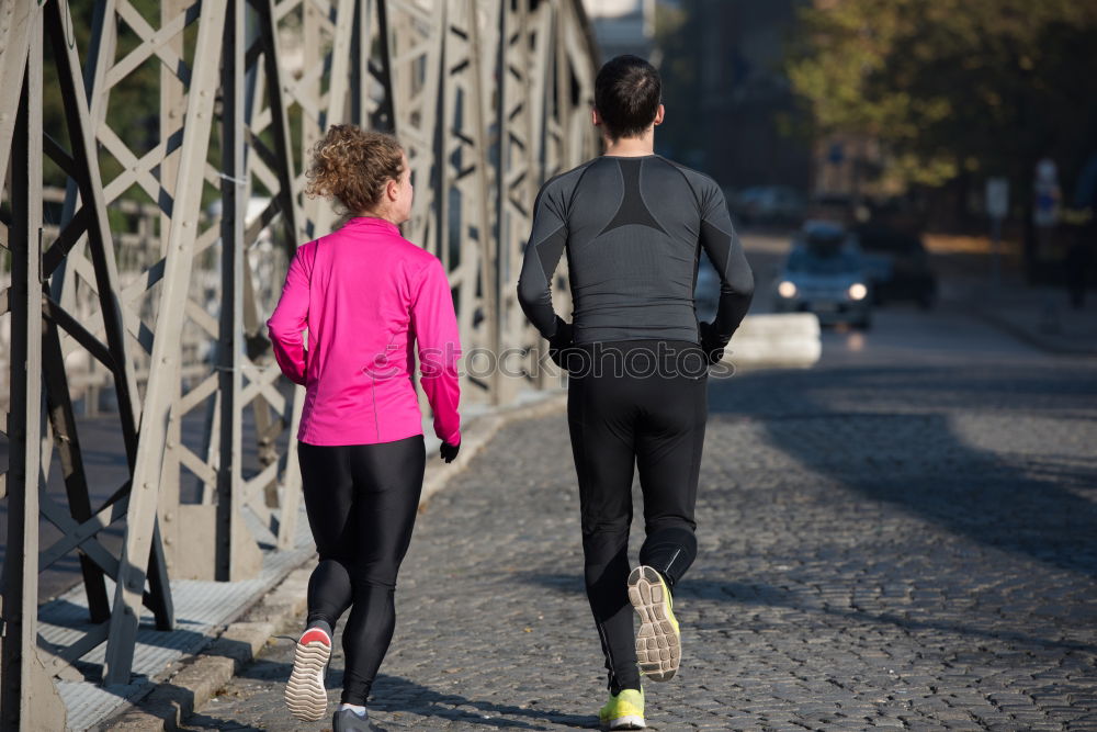 Similar – Young couple running on a seafront promenade