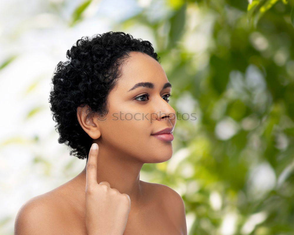 Similar – Black woman with afro hairstyle smiling in urban park.