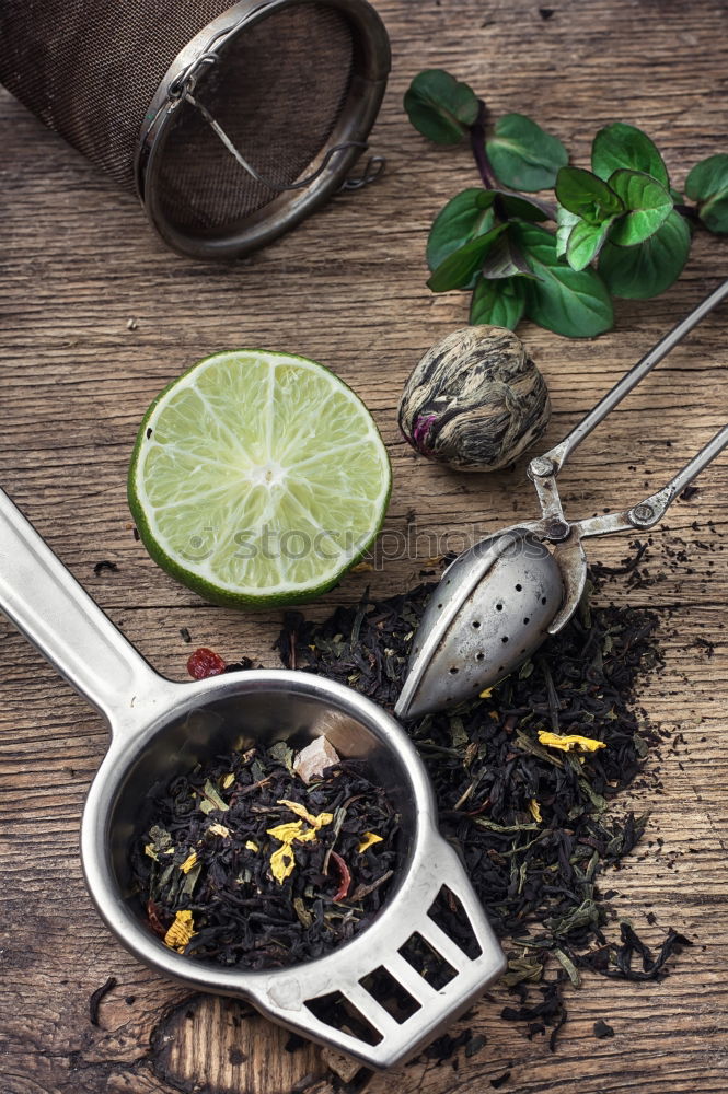 Similar – Black tea with jasmine in a white cup on a brown wooden table