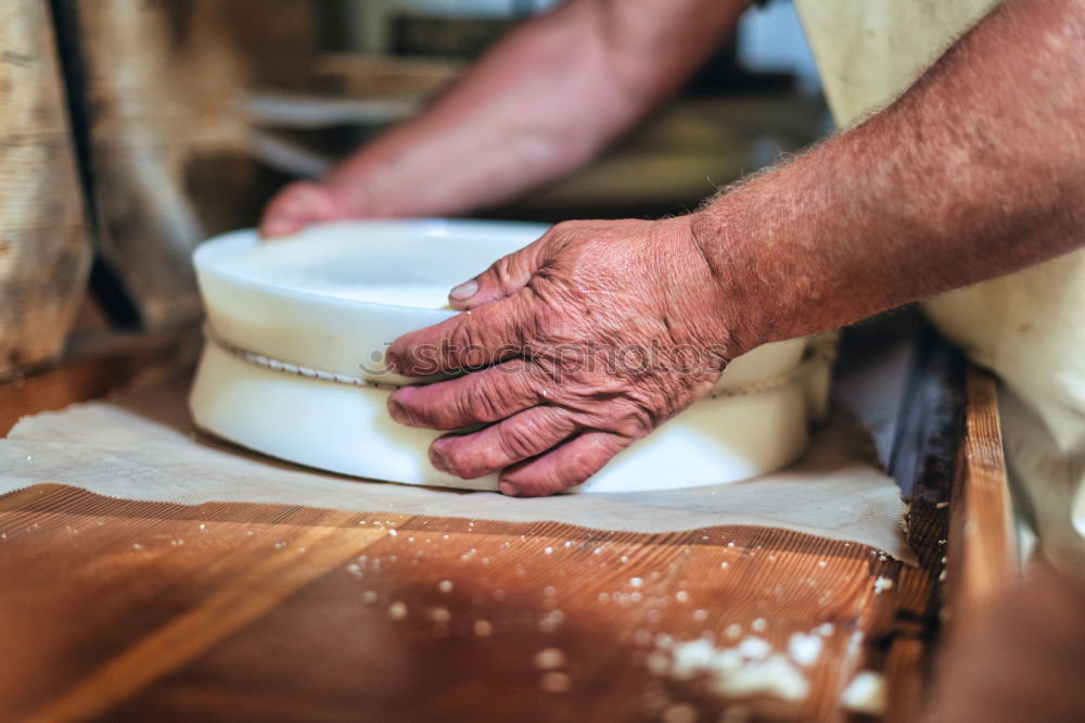 Similar – Professional carpenter cutting wooden board at his workshop