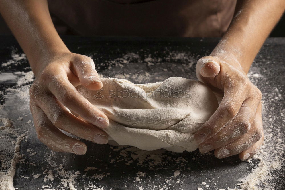 Similar – woman kneading bread dough with her hands