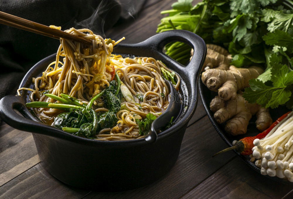Similar – Foto Bild Eine Person sitzt mit Essstäbchen in der Hand vor einer leckeren Pho Suppe in Vietnam