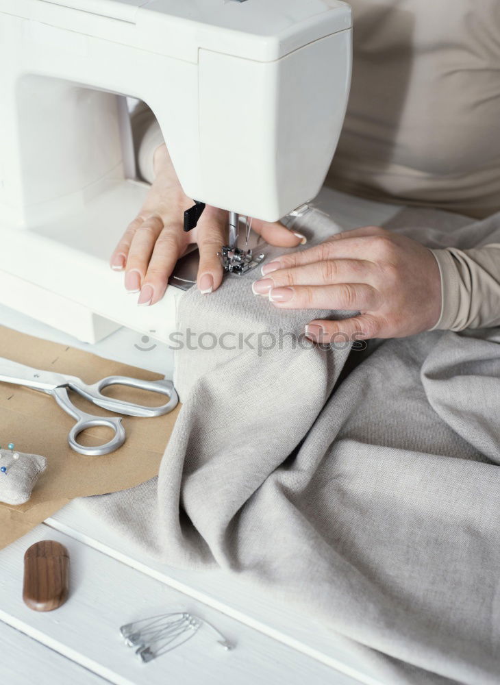 Similar – Women sew on sewing machine