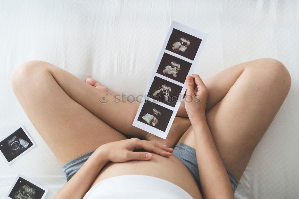 Similar – Image, Stock Photo pregnant woman sitting on the bench and loocking ultrasound scan at the day time. Concept of happy expectation.