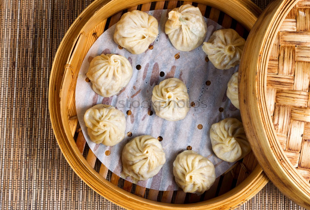 Similar – Dumplings or gyoza served in traditional steamer