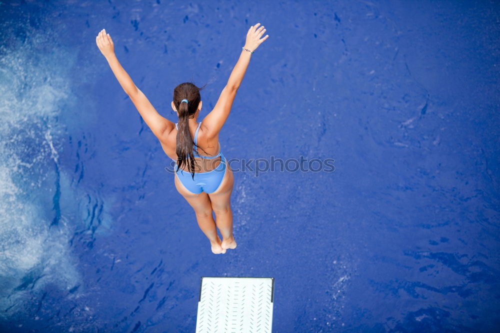 Similar – Woman swimming underwater in blue sea