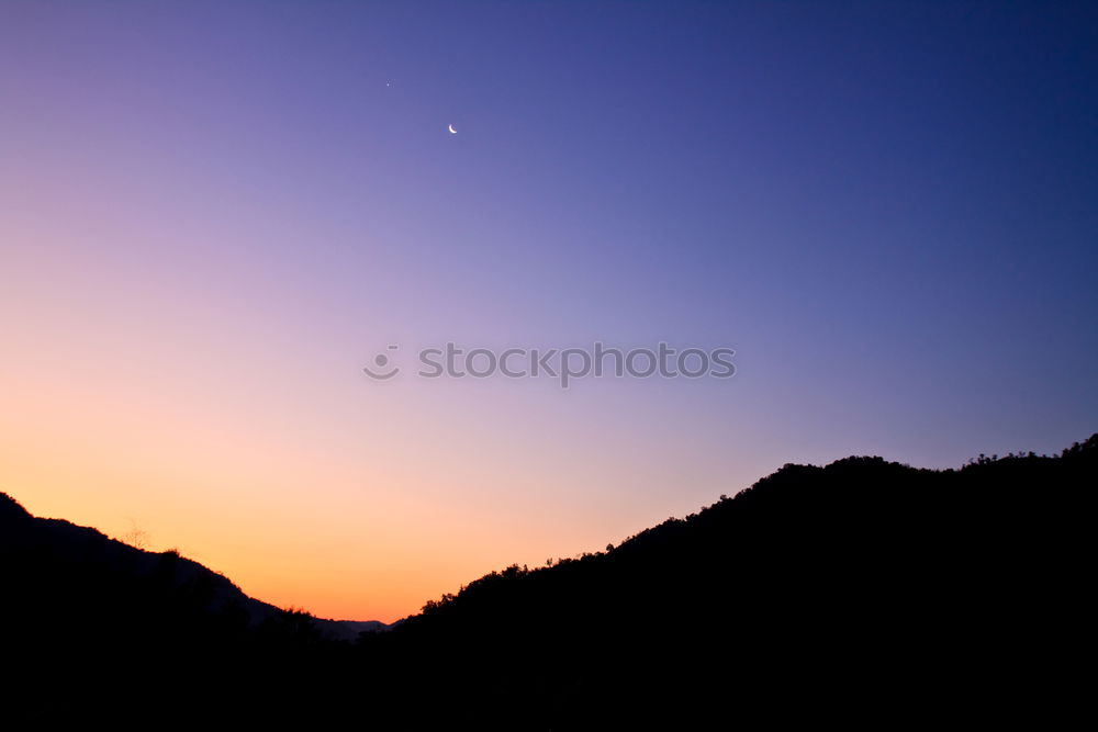 Similar – Mountain silhouette in sunset