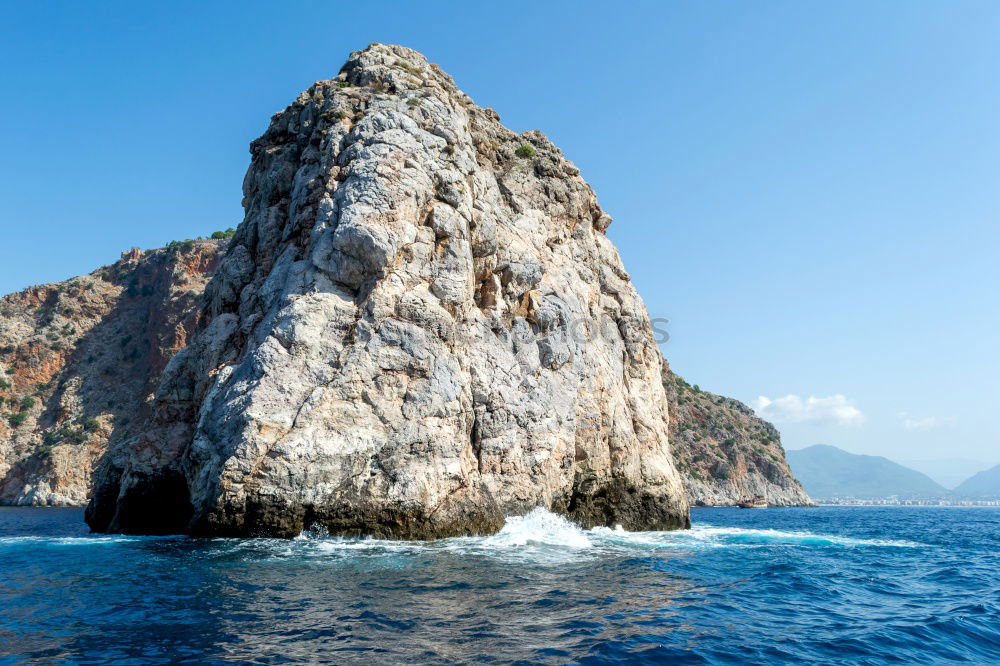 Similar – Rugged coast in the blue sea