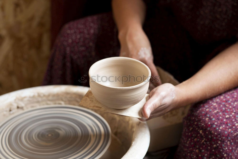 Similar – Hands of woodcarver make ??wooden bowl