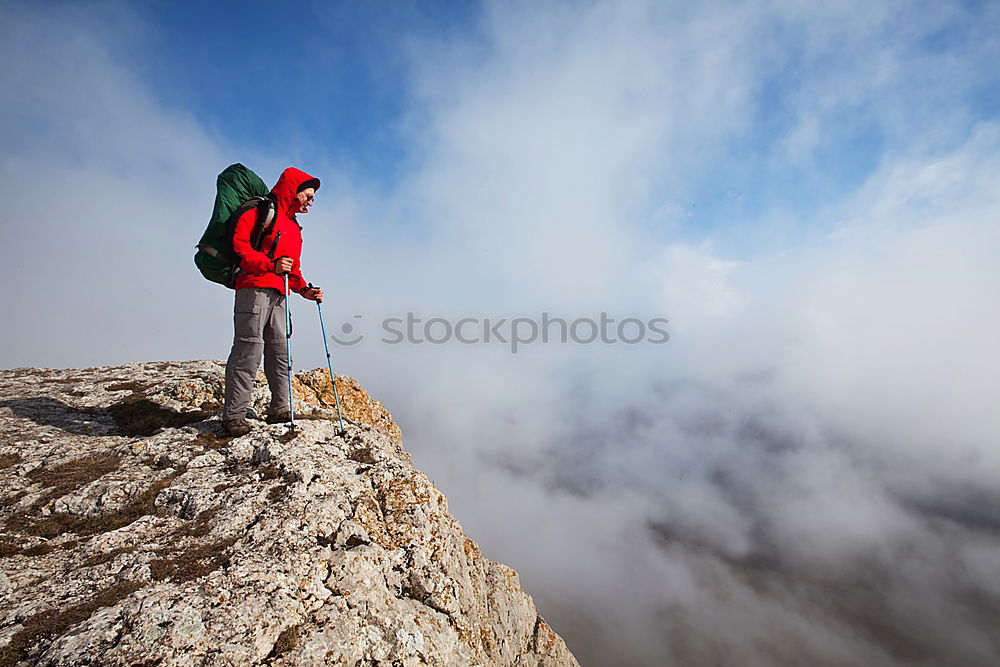 Similar – Male hiker standing on the top of a mountain.