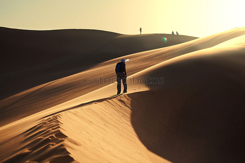 Similar – Image, Stock Photo Anonymous man walking on sand hills