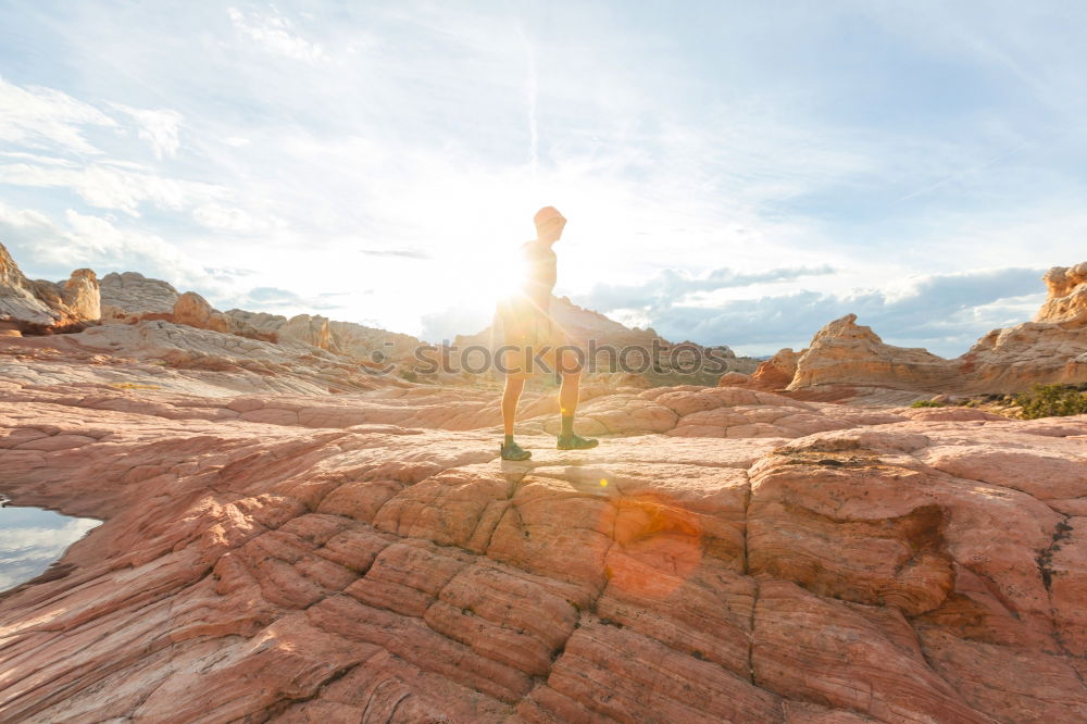 Similar – Man sitting on cliff