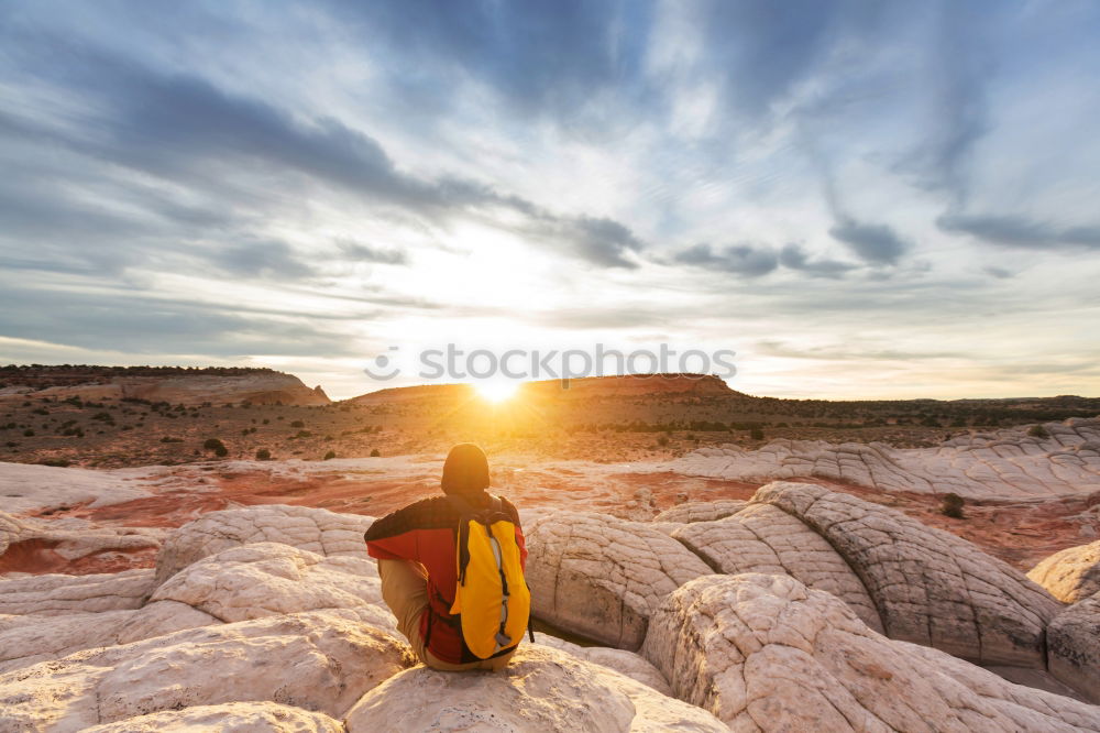 Similar – Man sitting on cliff