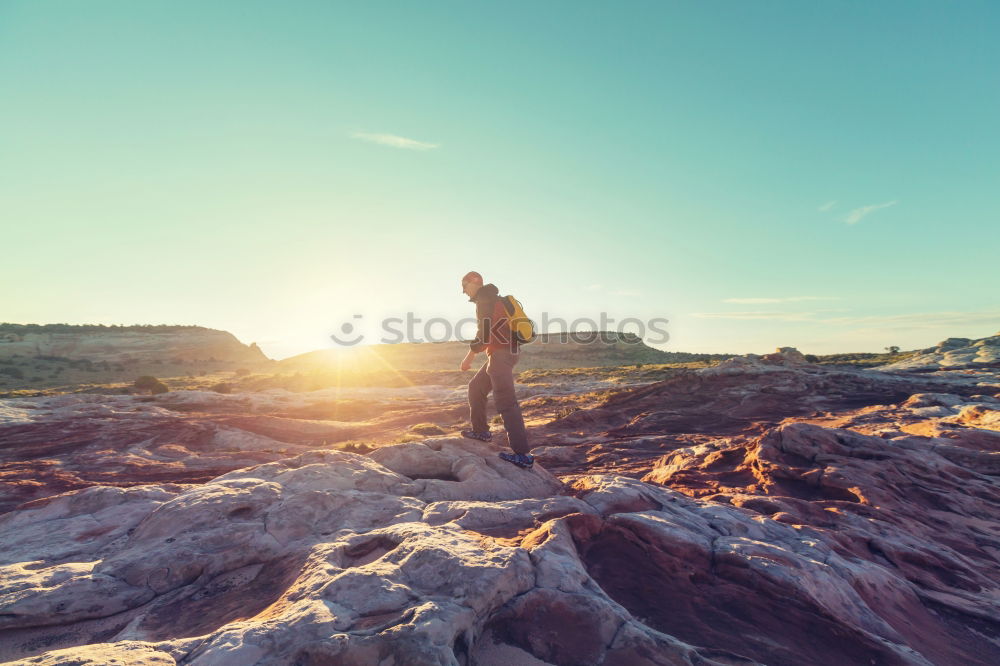 Similar – Man sitting on cliff