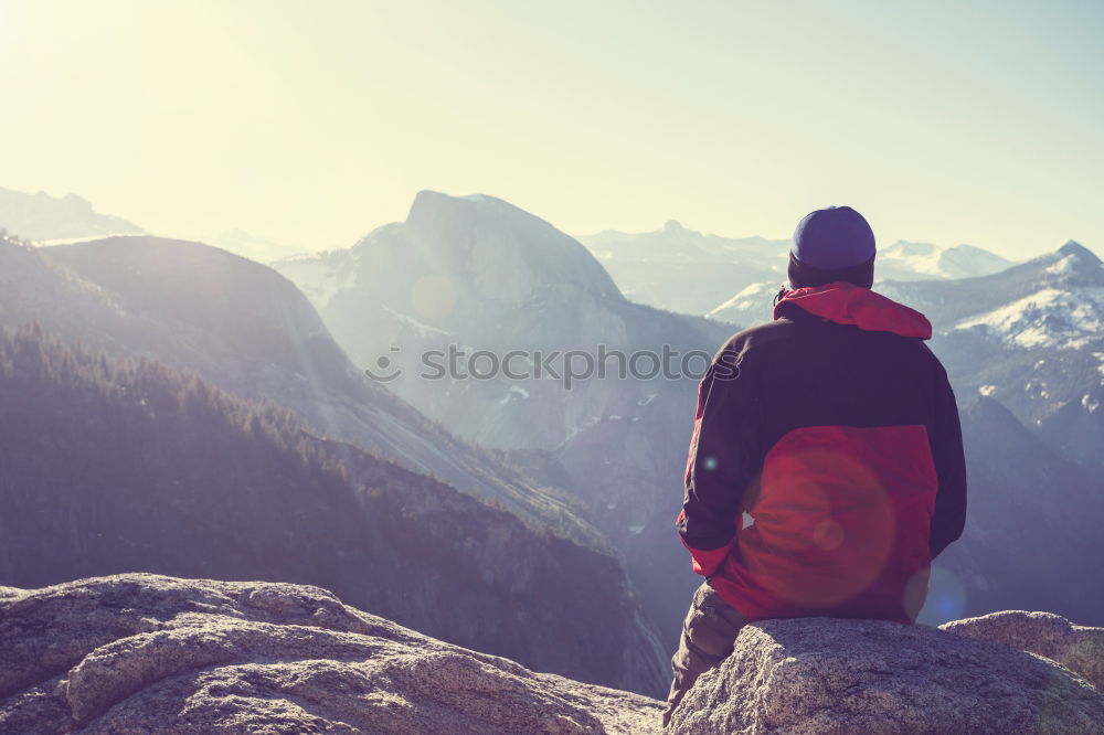 Similar – Image, Stock Photo Boy sitting on the rocks in the mountains and looking at a valley