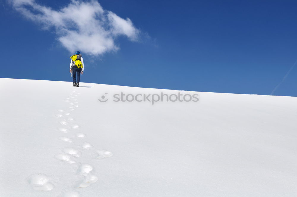 Similar – Skier in snowy landscape with hiking backpack