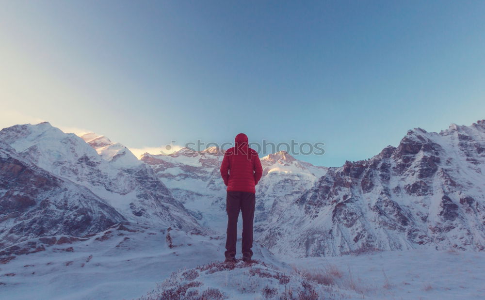 Similar – Tourist standing on stone in mountains