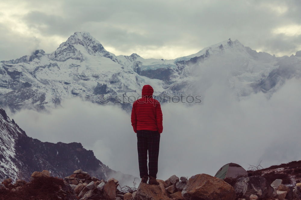 Similar – Tourist standing on stone in mountains