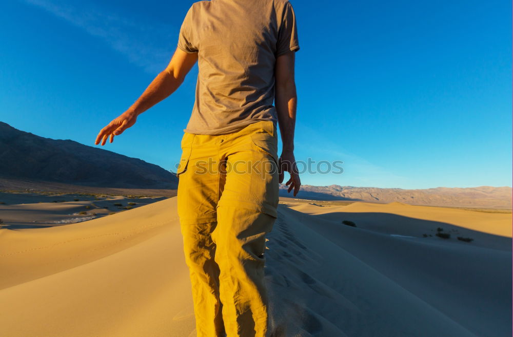 Similar – Image, Stock Photo Anonymous man walking on sand hills