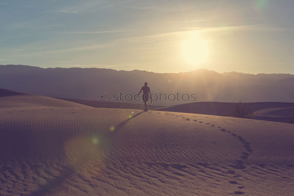 Similar – Image, Stock Photo Anonymous man walking on sand hills