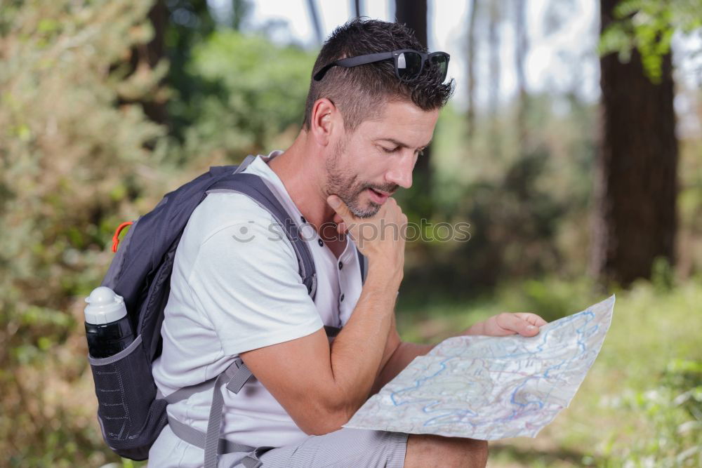 Similar – Man navigating on road in woods