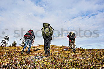 Similar – Four people with hiking backpacks, mountain landscape, Scandinavia