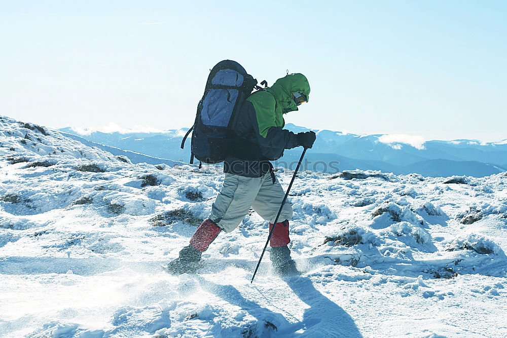 Similar – Image, Stock Photo Skier with rucksack in a snowy landscape, looking backwards