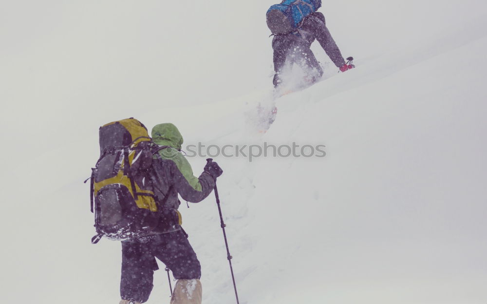 Similar – Female climber in the storm during an extreme winter climb