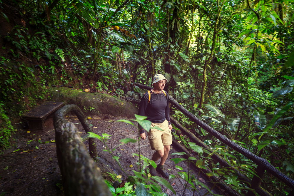 Similar – young woman standing in front of tropical waterfall