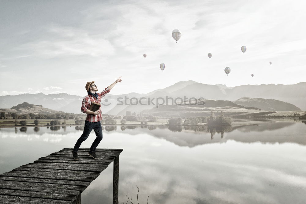 Similar – Backpacker jumping on landscape